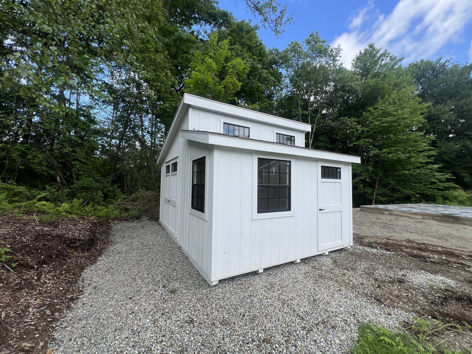 Ridgeview Studio Lean To shed exterior in white with transom windows
