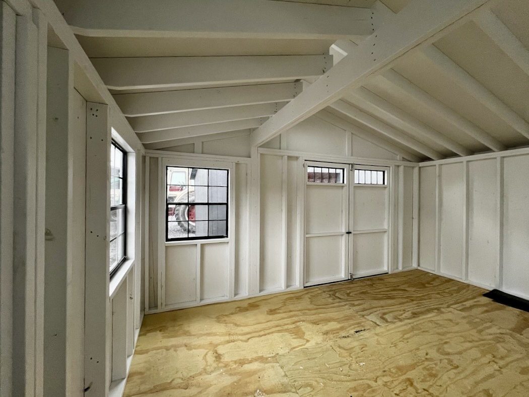 Ridgeview Studio Lean To shed interior with exposed rafters and natural light